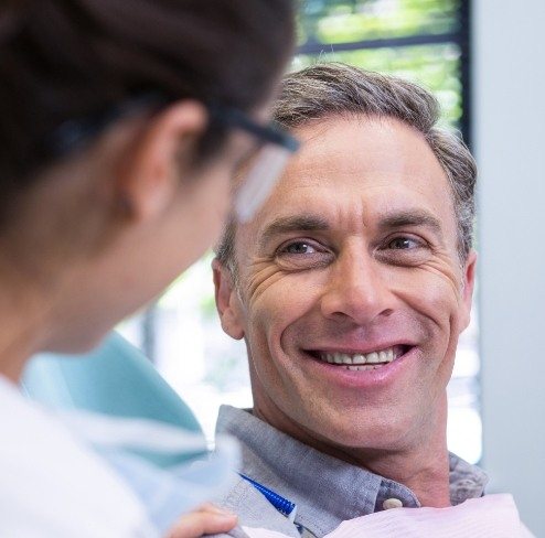 Man sharing smile after dental bridge restoration