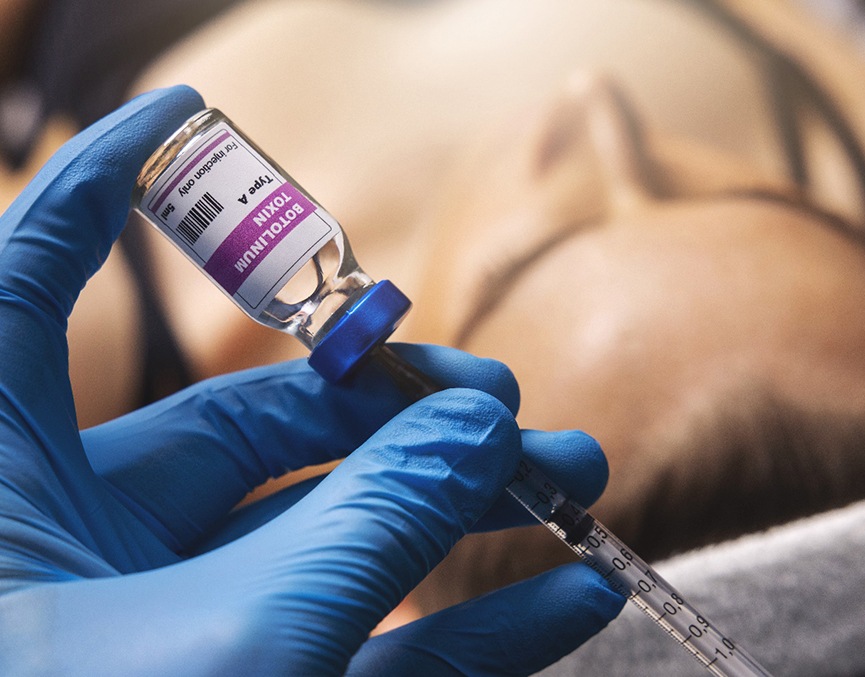 a hand preparing a syringe of BOTOX