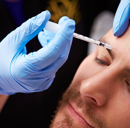 a man receiving BOTOX in his forehead