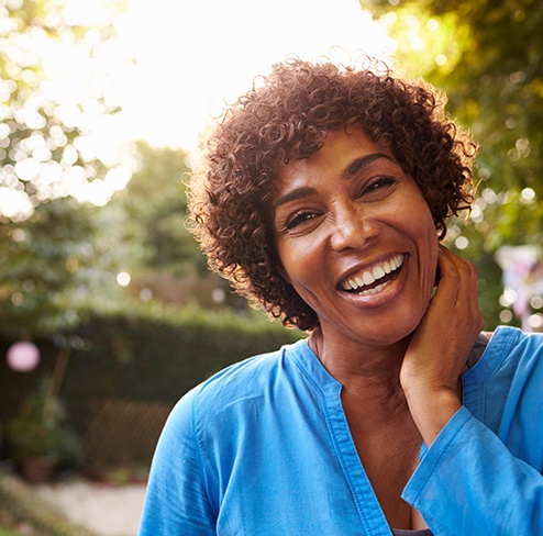 smiling woman standing in a park