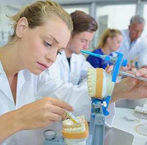 A female lab technician working on dentures