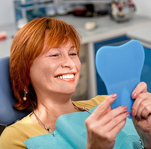 A smiling senior woman enjoying her new dentures