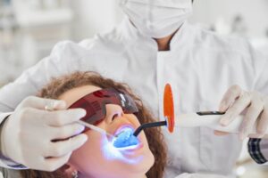Woman receiving high-tech looking laser dentistry treatment
